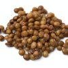 Heap of preserved steamed brown lentils close up on white background
